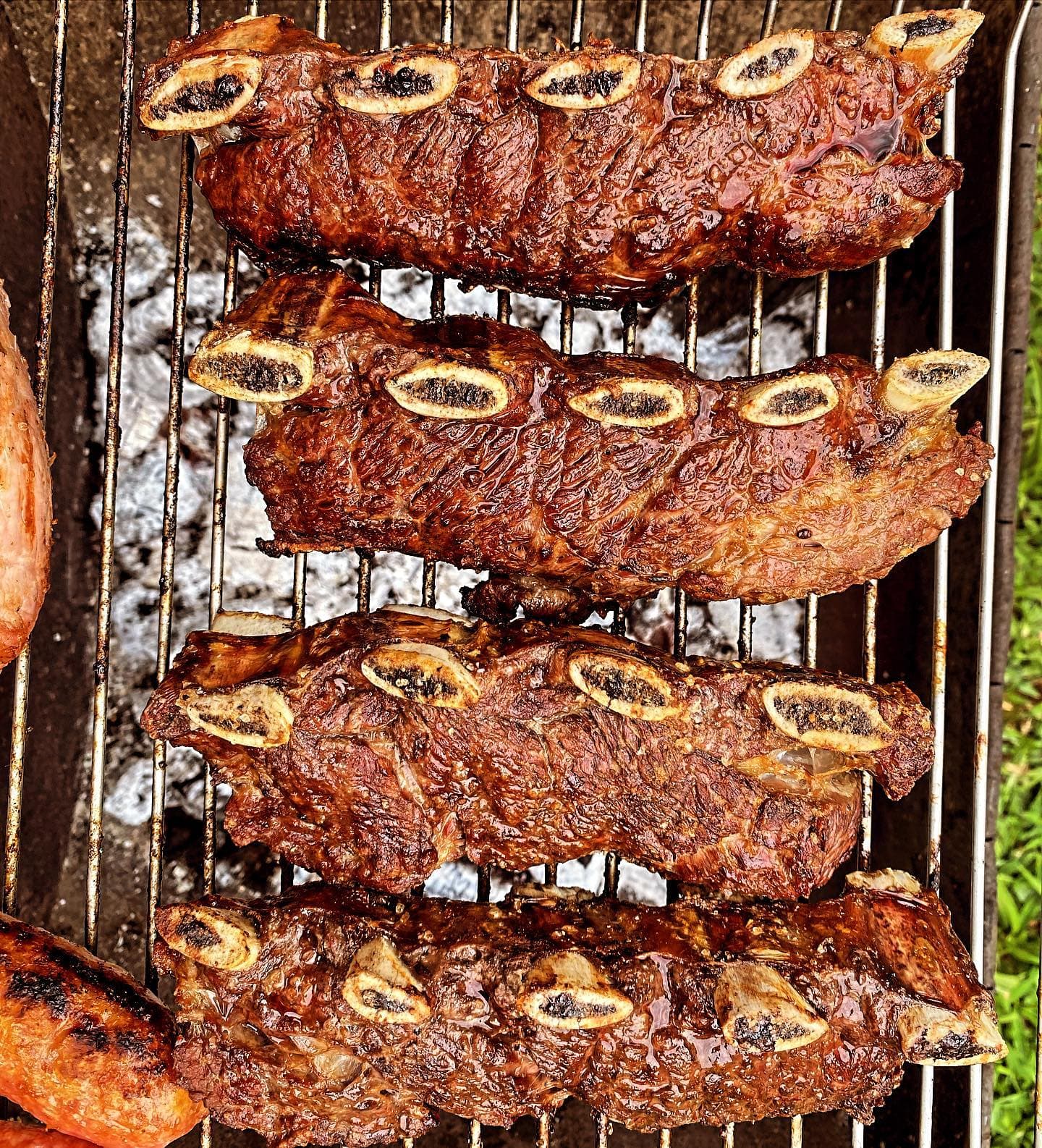 Costelas assando na grelha sobre a brasa